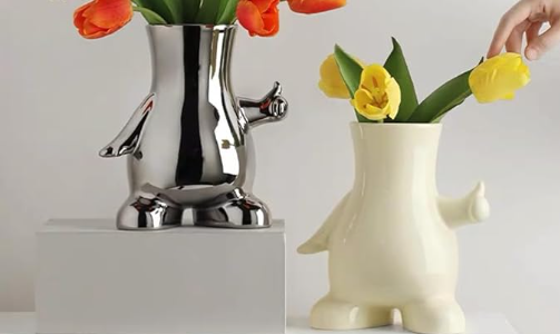 Pair of human-shaped vases with flowers in it