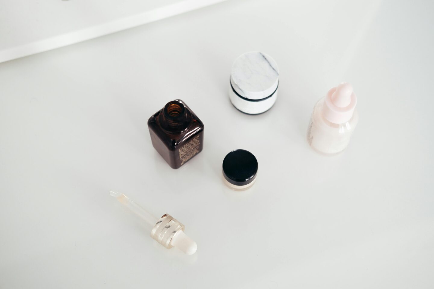 Assorted cosmetics on white counter