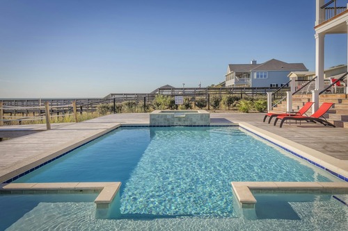 swimming pool with chairs on the side